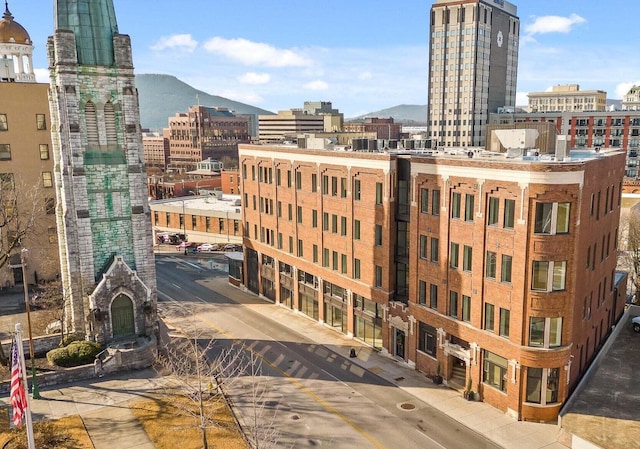 property's view of city with a mountain view