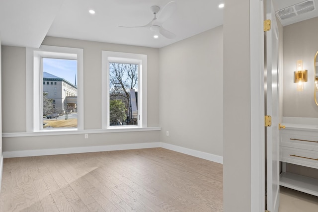 interior space featuring recessed lighting, visible vents, a ceiling fan, baseboards, and light wood-style floors