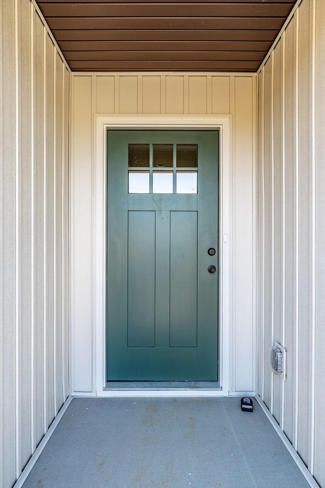 view of exterior entry featuring board and batten siding