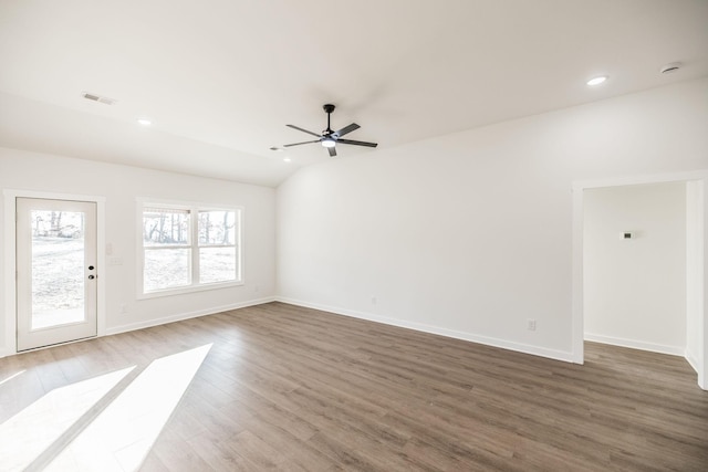 unfurnished living room featuring recessed lighting, wood finished floors, visible vents, baseboards, and lofted ceiling