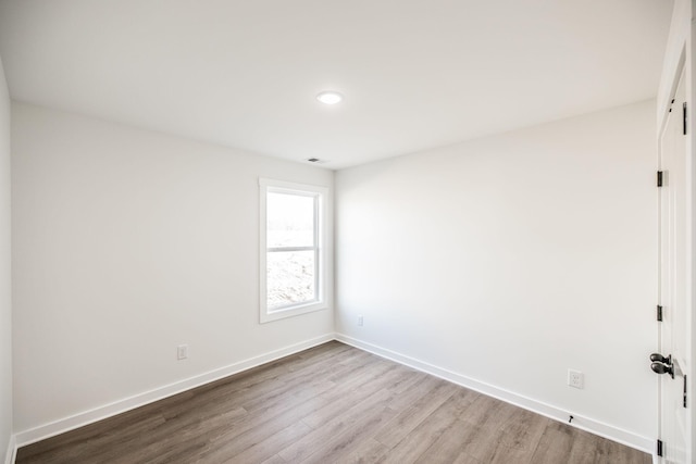 unfurnished room featuring light wood finished floors and baseboards