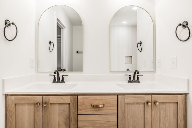 full bath featuring double vanity and a sink