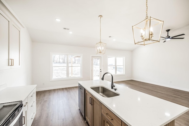 kitchen featuring a sink, open floor plan, a kitchen island with sink, visible vents, and stainless steel dishwasher