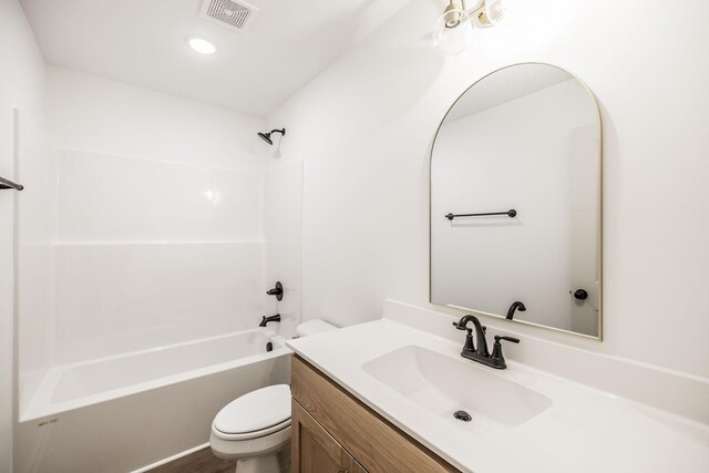 full bathroom featuring toilet, bathing tub / shower combination, visible vents, and vanity