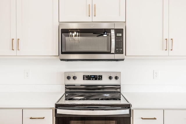 kitchen featuring white cabinetry, appliances with stainless steel finishes, and light countertops