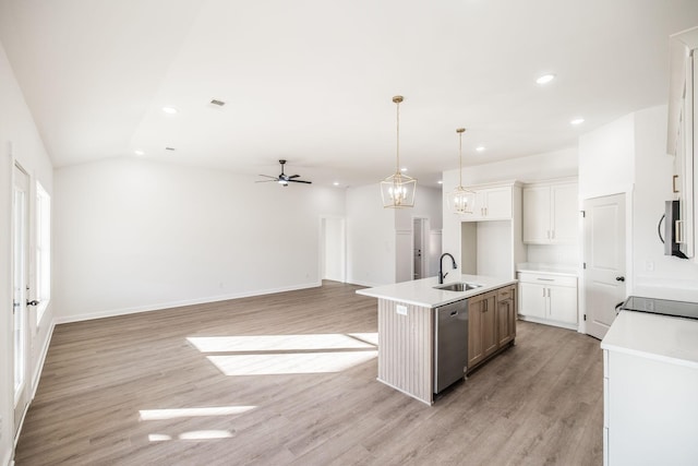 kitchen featuring open floor plan, light countertops, white cabinetry, an island with sink, and stainless steel appliances