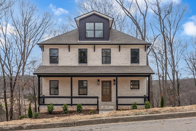 view of front of house featuring covered porch, roof with shingles, and brick siding