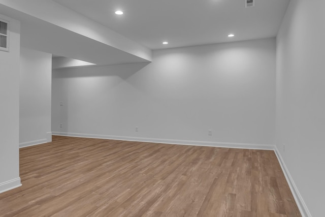 basement featuring light wood-style floors, recessed lighting, and baseboards