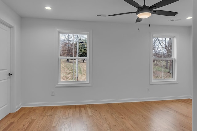 empty room with baseboards, visible vents, and a healthy amount of sunlight