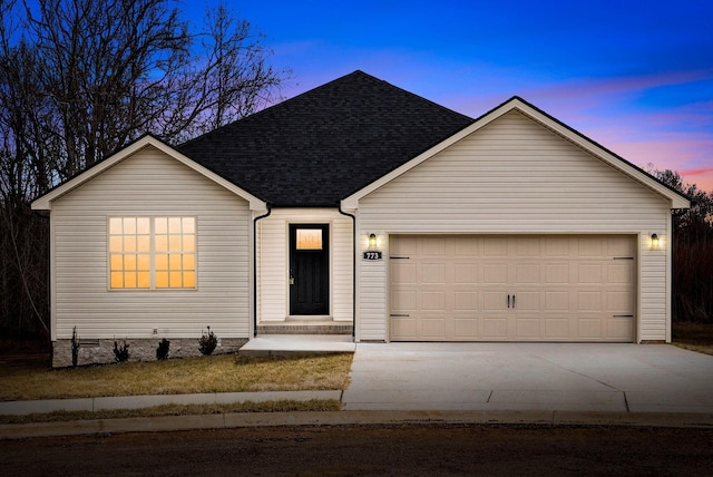 single story home with an attached garage, concrete driveway, and roof with shingles