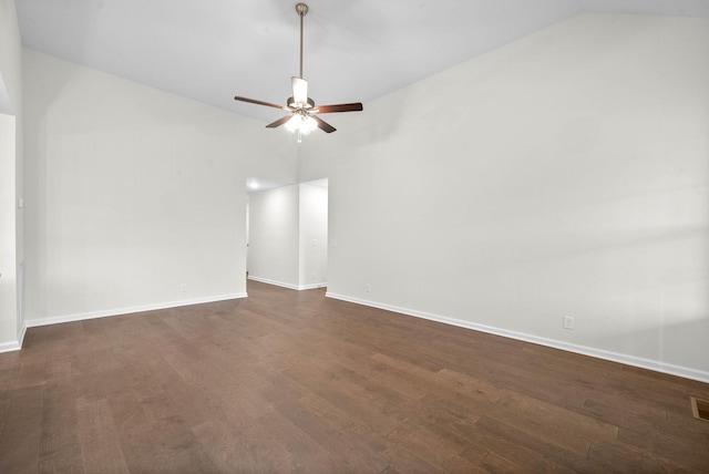 empty room featuring visible vents, baseboards, dark wood-style floors, ceiling fan, and vaulted ceiling