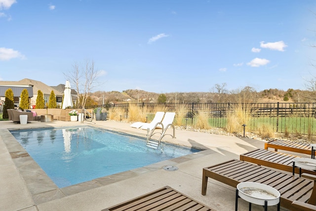 view of swimming pool featuring a fenced backyard, a fenced in pool, and a patio