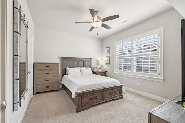 bedroom with visible vents, ceiling fan, light carpet, and baseboards