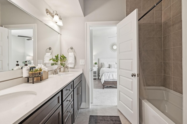 ensuite bathroom with connected bathroom, a sink, shower / bathing tub combination, tile patterned floors, and double vanity