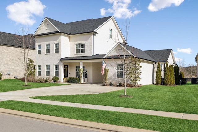 view of front of property with a front lawn and brick siding