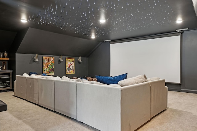 cinema room featuring lofted ceiling and light colored carpet