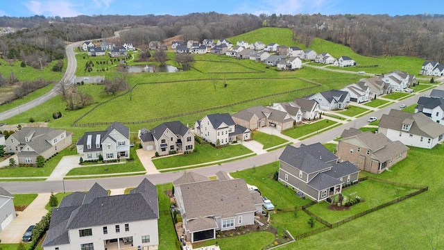 drone / aerial view with a water view and a residential view