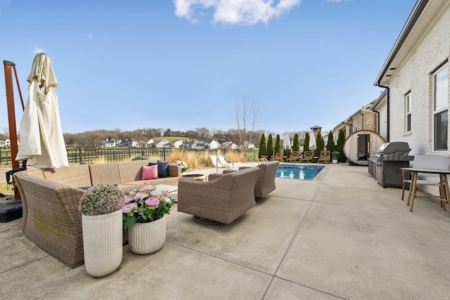 view of patio with a fenced in pool, a grill, an outdoor living space, and fence