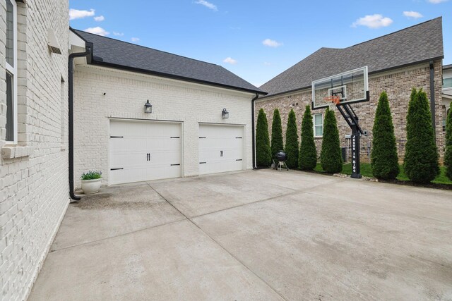 7020 Vineyard Valley Dr, College Grove, TN 37046 - view of side of home featuring a shingled roof, brick siding, and driveway