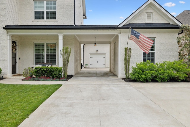7020 Vineyard Valley Dr, College Grove, TN 37046 - view of front of house featuring brick siding, concrete driveway, a front yard, and covered porch