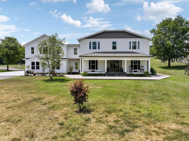 7609 Nolensville Rd, Nolensville, TN 37135 - view of front of property featuring covered porch, metal roof, a front lawn, and a standing seam roof
