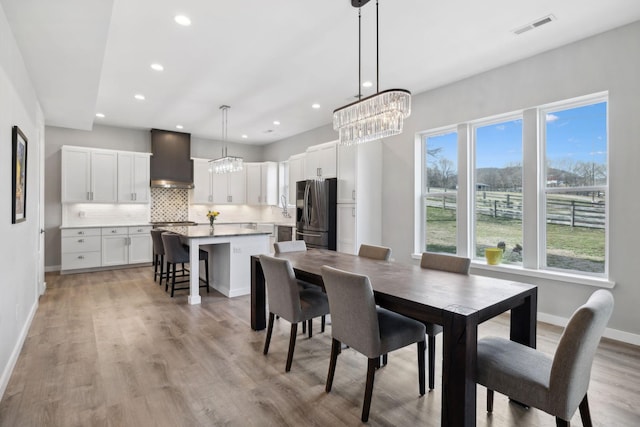 7609 Nolensville Rd, Nolensville, TN 37135 - dining room with light wood finished floors, recessed lighting, visible vents, an inviting chandelier, and baseboards
