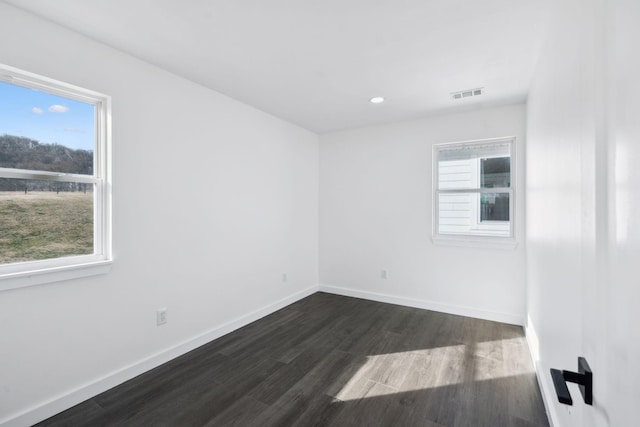7609 Nolensville Rd, Nolensville, TN 37135 - empty room featuring dark wood-style floors, baseboards, visible vents, and recessed lighting
