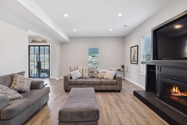 7609 Nolensville Rd, Nolensville, TN 37135 - living room featuring light wood-style flooring, recessed lighting, a lit fireplace, and baseboards