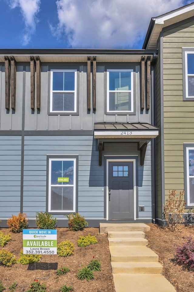 property entrance featuring board and batten siding