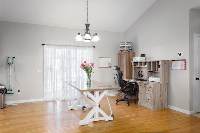 home office featuring a chandelier, light wood-type flooring, high vaulted ceiling, and baseboards