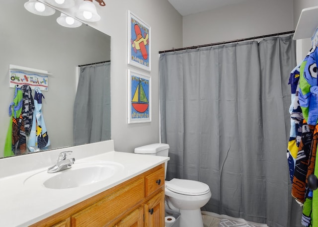 bathroom with toilet and vanity