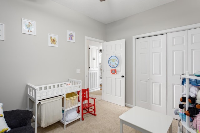 bedroom featuring light carpet and a closet