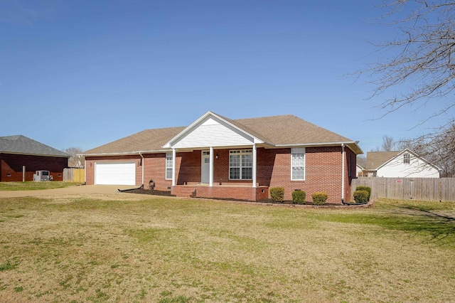 view of front of house with a front yard, concrete driveway, brick siding, and an attached garage