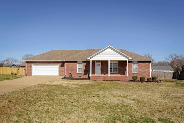 ranch-style house featuring a garage, driveway, brick siding, and fence