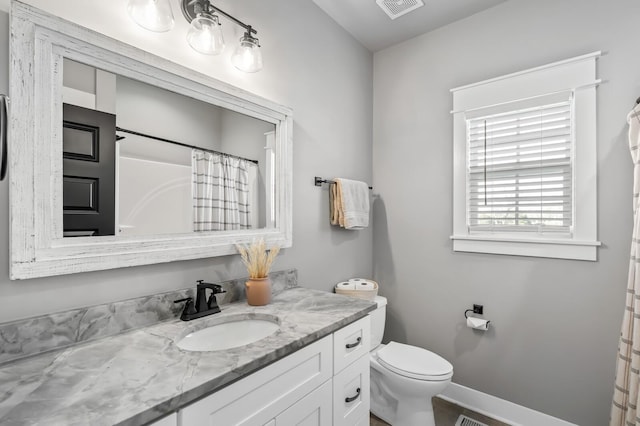 bathroom featuring baseboards, visible vents, toilet, curtained shower, and vanity