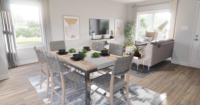 dining area with baseboards, a wealth of natural light, and light wood-style floors