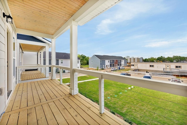 wooden deck with a residential view and a yard