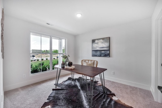 office area featuring baseboards, visible vents, and carpet flooring