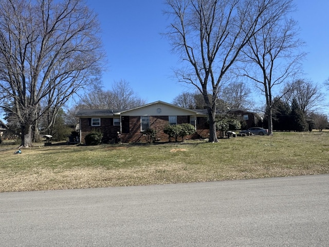 single story home featuring a front lawn and brick siding