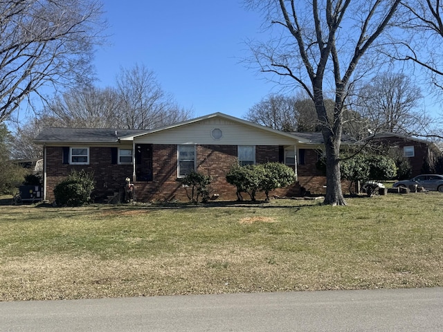 single story home with brick siding and a front yard