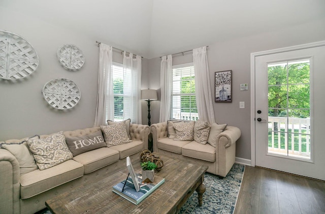 living area with dark wood-style flooring and baseboards