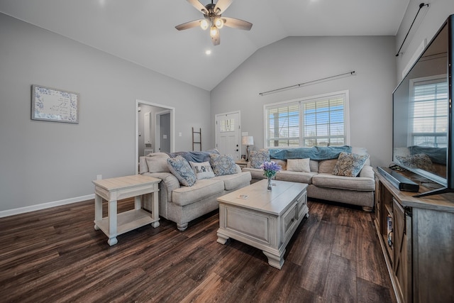 living area featuring high vaulted ceiling, a wealth of natural light, dark wood-style flooring, and a ceiling fan