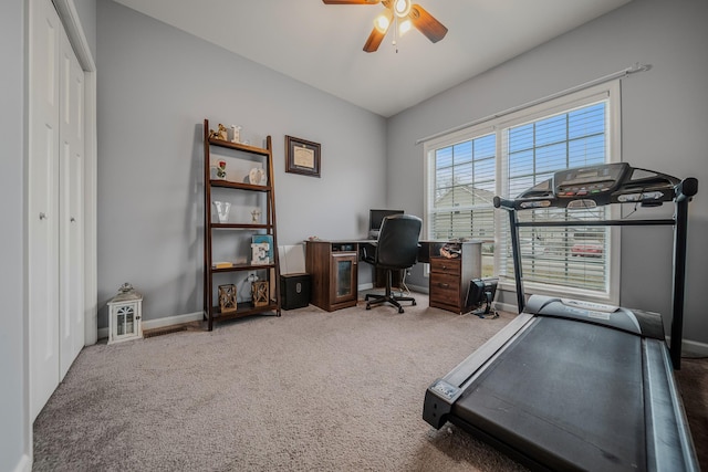 carpeted office with ceiling fan and baseboards