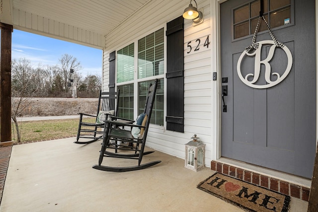 view of exterior entry featuring a porch