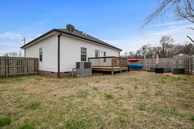 back of property featuring a fenced backyard, central AC, a lawn, crawl space, and a wooden deck