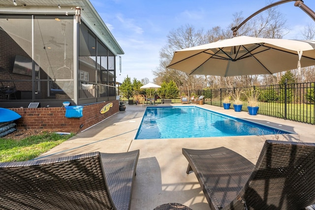 view of pool featuring a sunroom, fence, and a fenced in pool