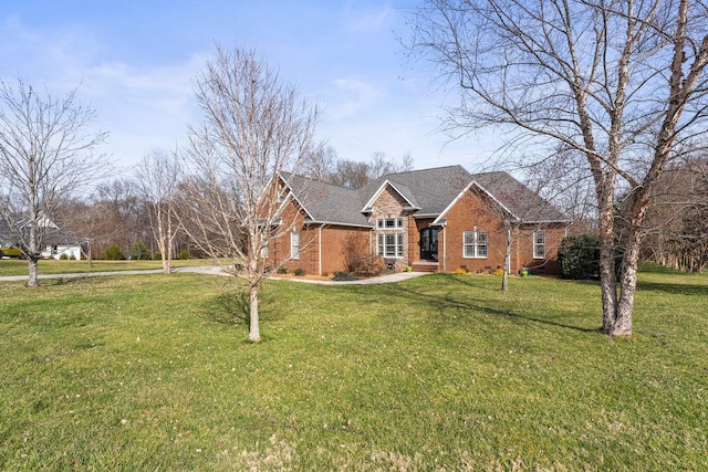 view of front of house with brick siding and a front lawn