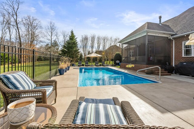 view of pool featuring a sunroom, a patio area, fence, and a fenced in pool