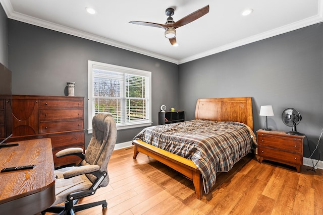 bedroom with ornamental molding, baseboards, and light wood finished floors