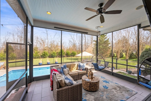 sunroom featuring ceiling fan